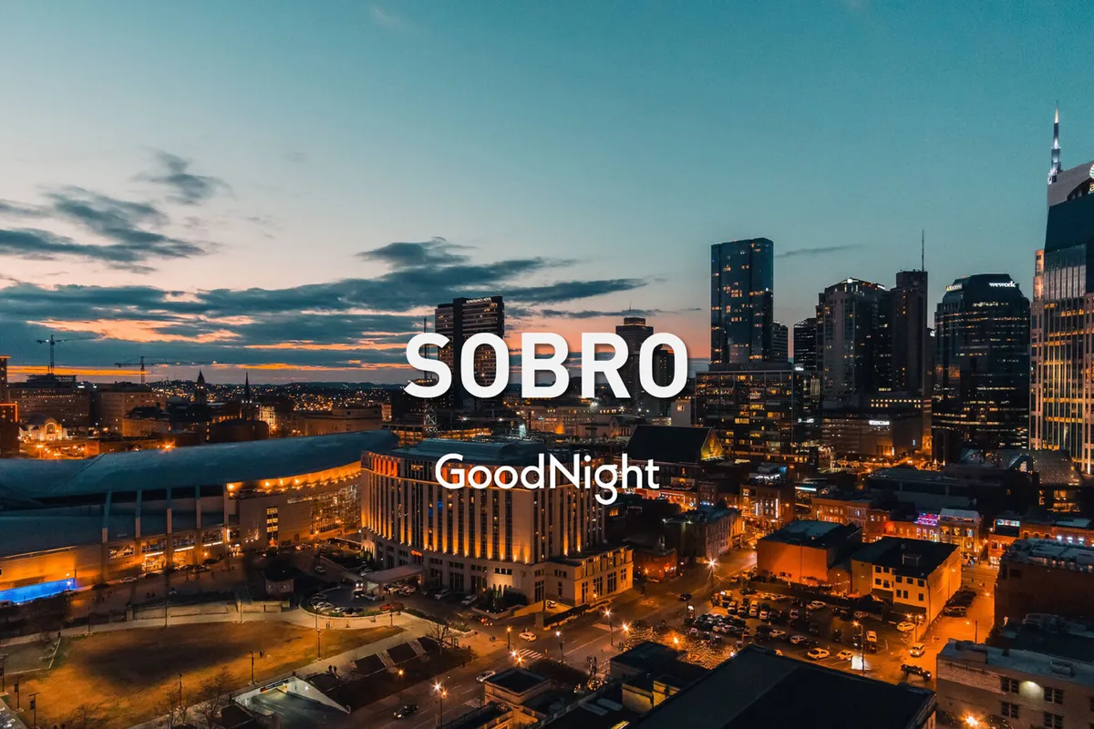 A panoramic view of the Nashville city skyline at sunset, transitioning into a nightscape where city lights begin to twinkle. The scene exudes excitement and energy, inviting viewers to explore the city’s after-dark offerings.